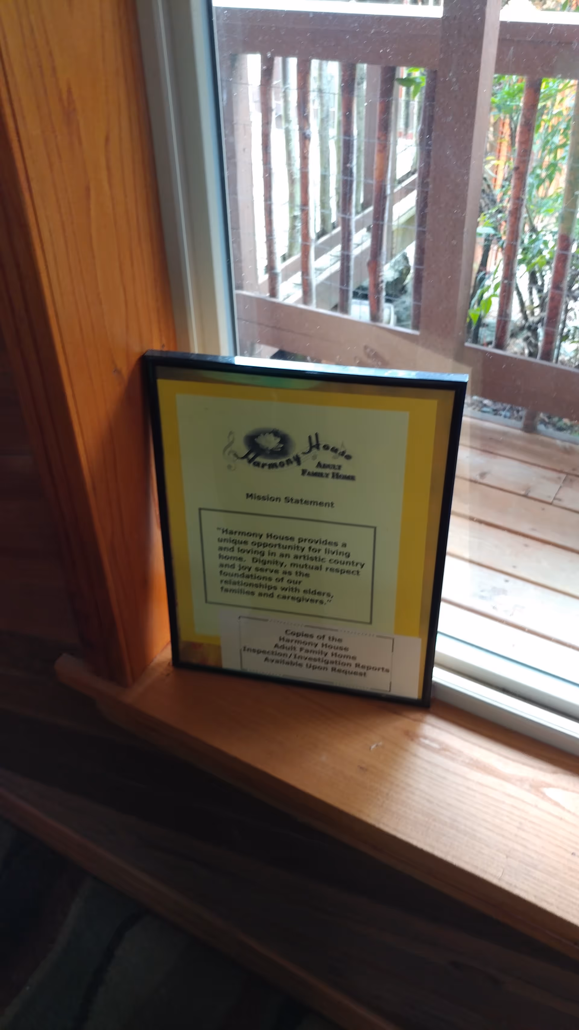 Framed mission statement on a wooden window sill inside Harmony House Adult Family Home.