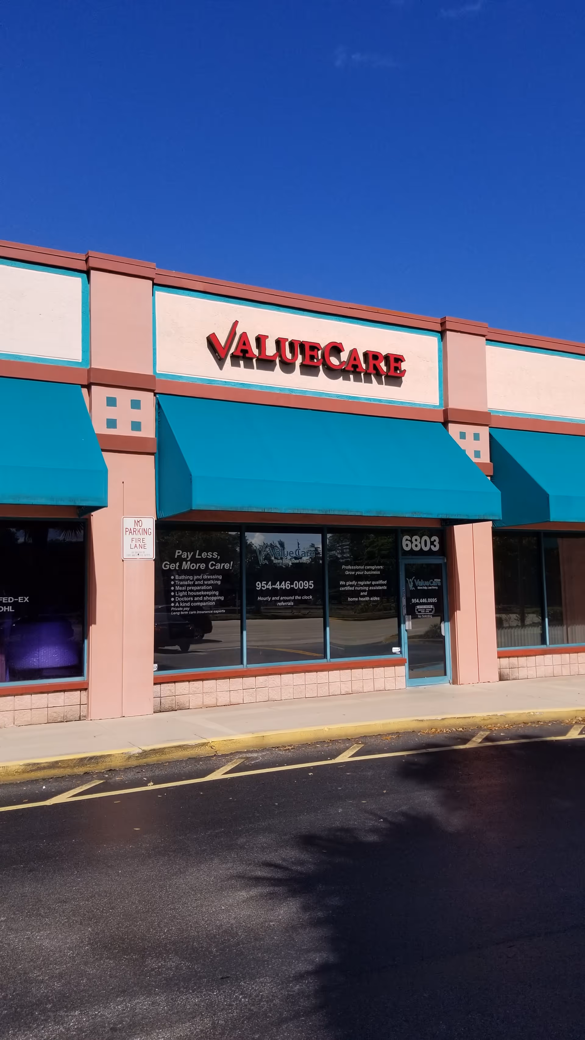 Front view of ValueCare facility storefront with teal awnings and blue sky.