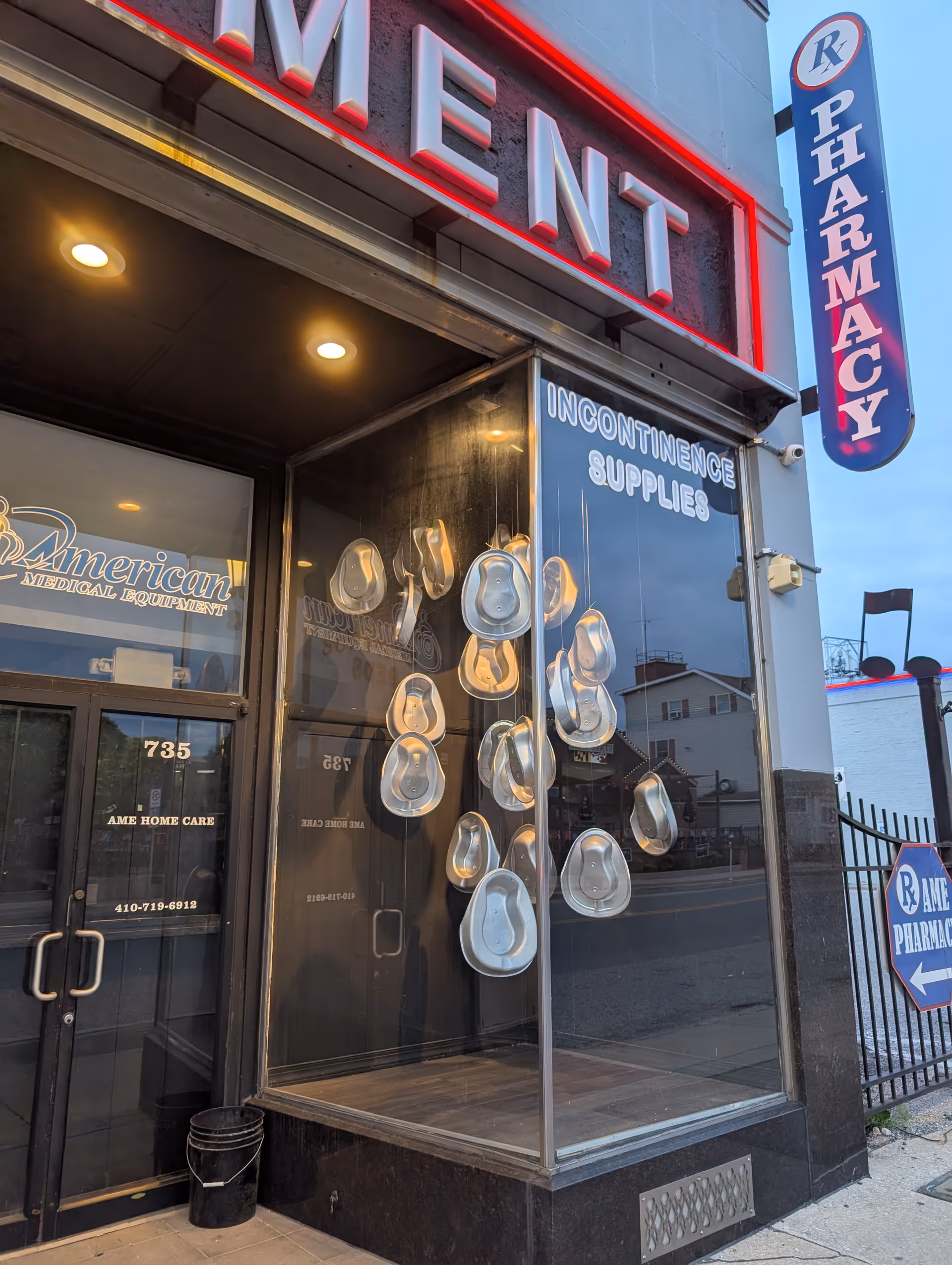 Exterior storefront of AME Home Care with window display of hats and incontinence supplies.