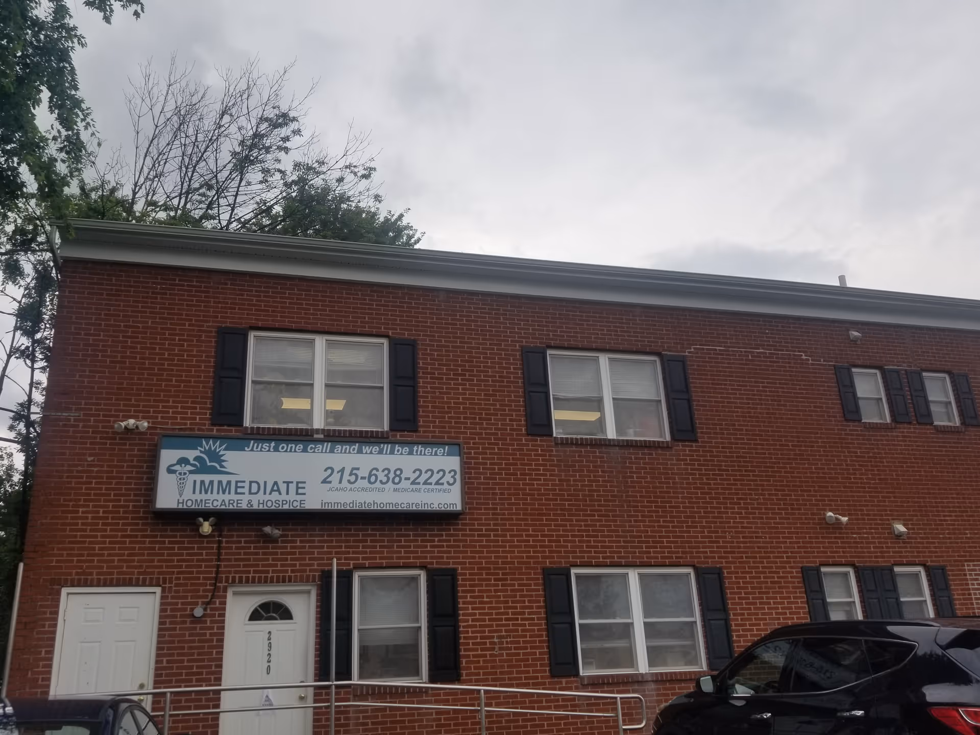 Brick two-story building with a sign for Immediate Home Care and Hospice on the front.