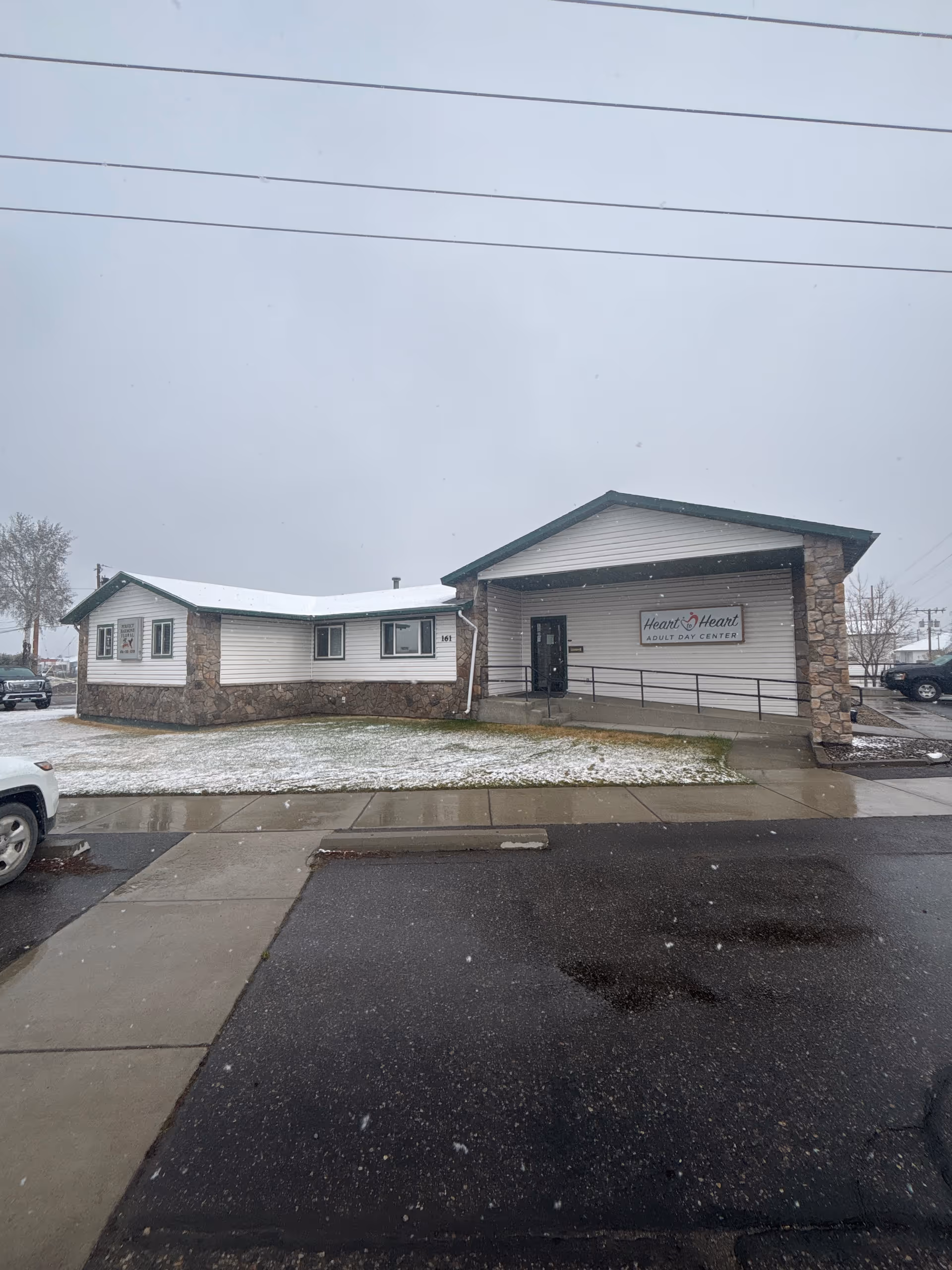 Front view of Heart to Heart Adult Day Center building in snowy weather.