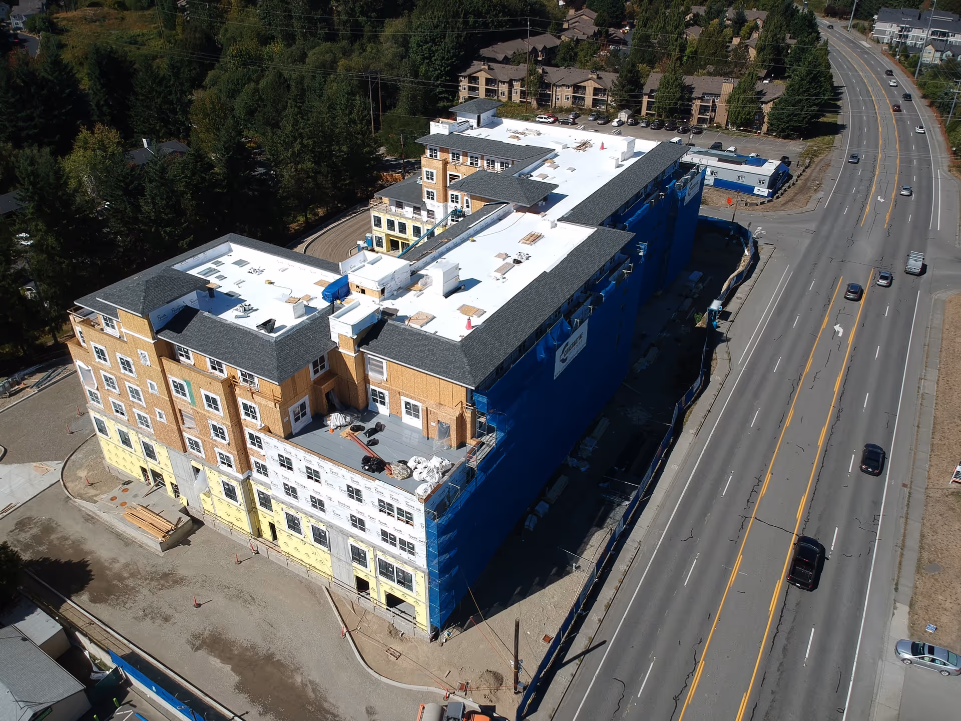 Aerial view of Vineyard Park at North Creek under construction beside a major road.