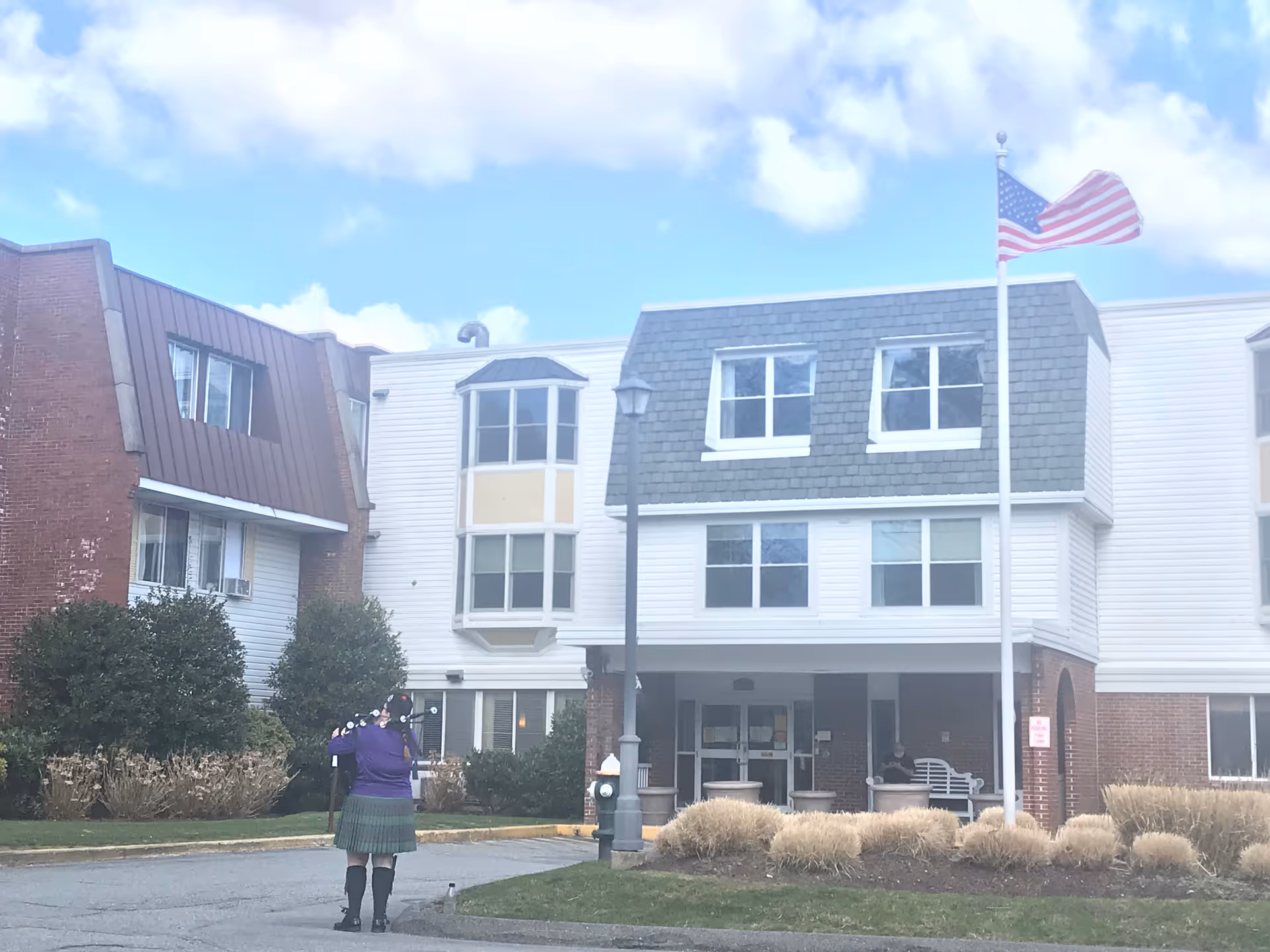 Exterior view of Cape Regency Rehabilitation & Health Care Center with flagpole.