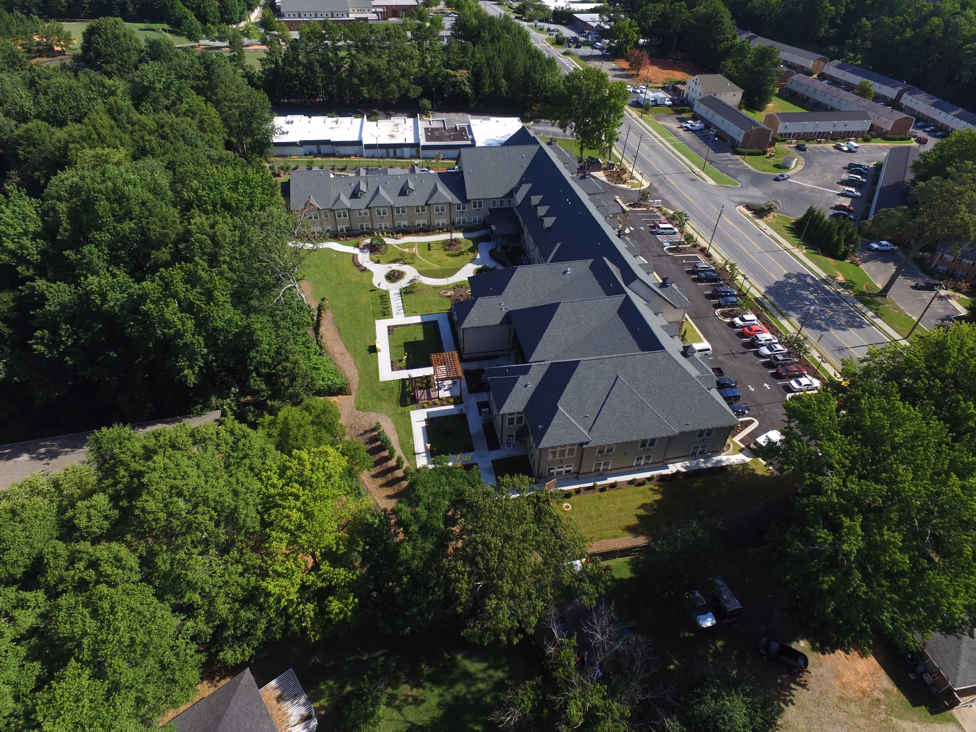 Aerial view of Orchard Senior Living campus with connected buildings, parking, and trees.