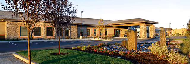 Front exterior of Suite Living Senior Care facility in Inver Grove Heights with stone accents.