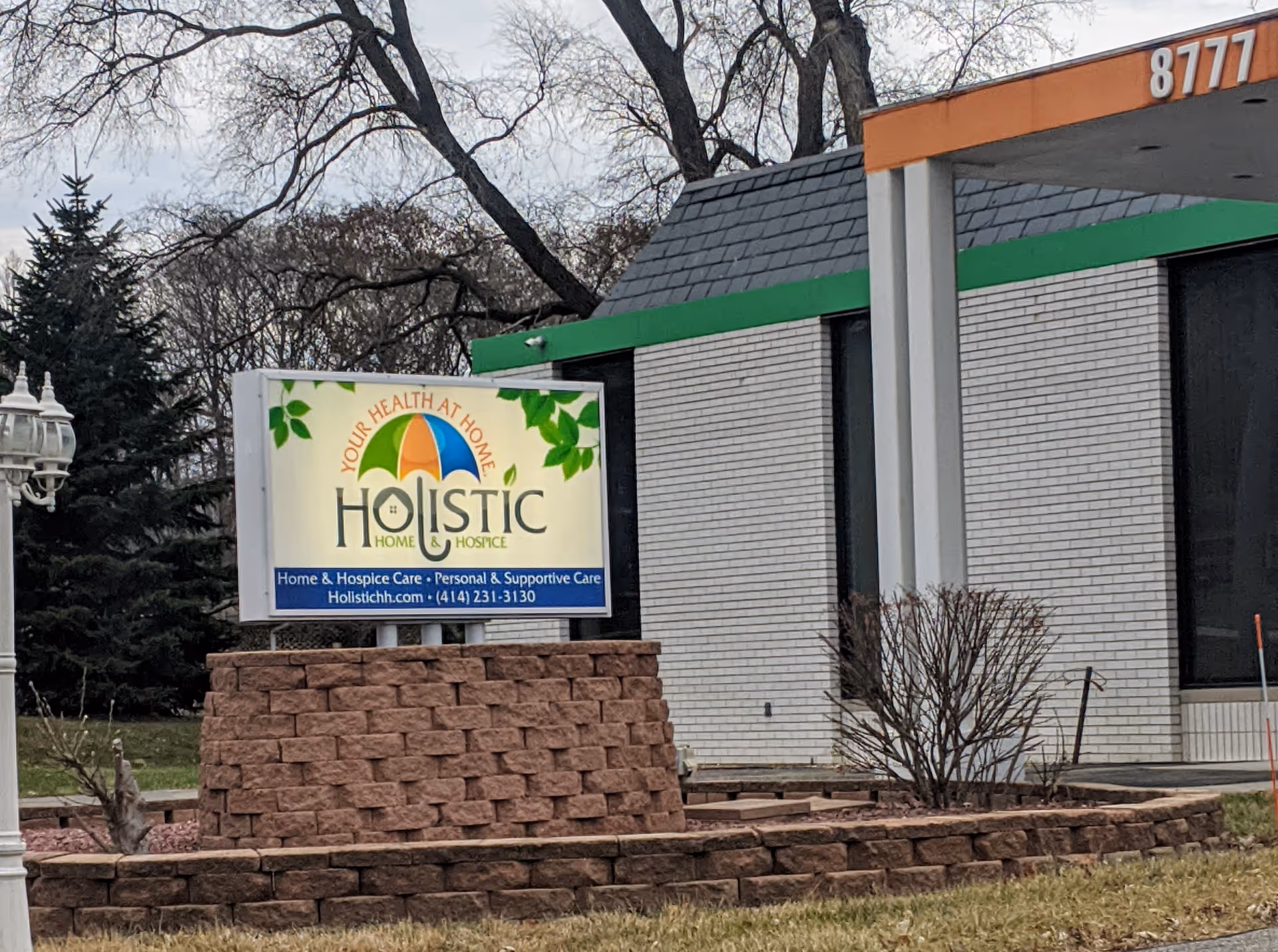 Exterior view of Holistic Home and Hospice Care sign in front of the building.