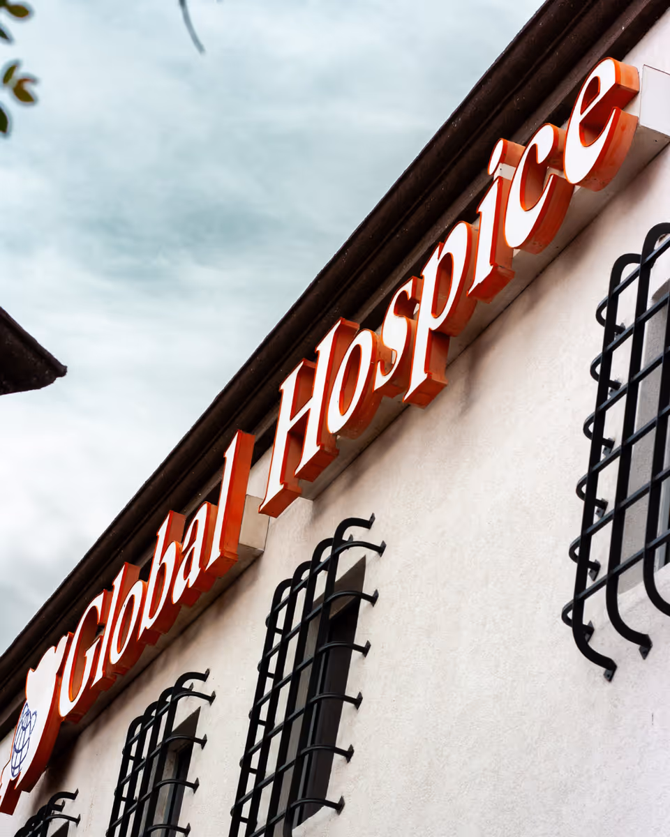 Exterior view of a building with a Global Hospice Care sign along the facade.