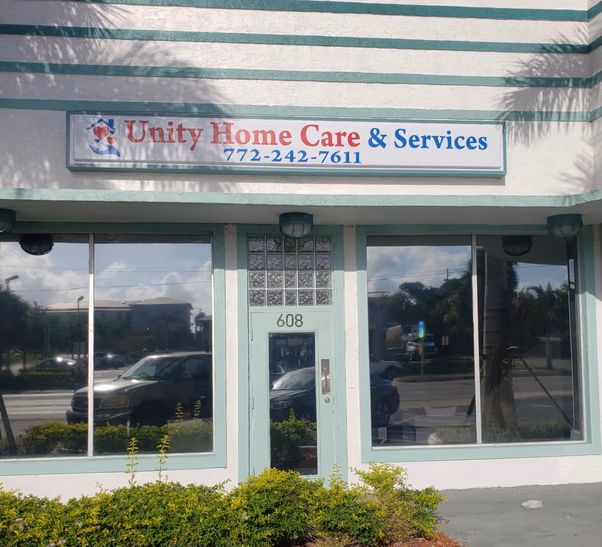 Front exterior of Unity Home Care & Services building with large windows and sign.