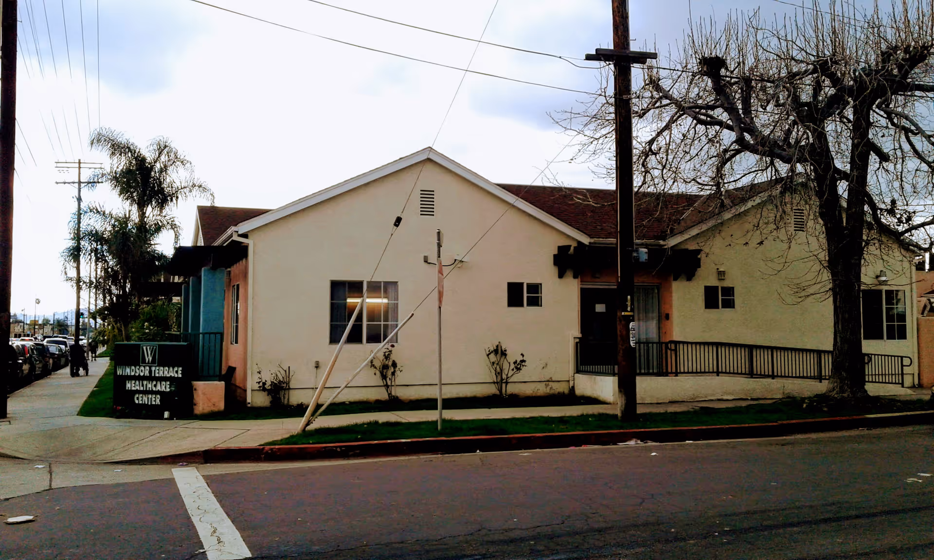 A single-story beige building labeled Windsor Terrace Healthcare Center sits along a street.