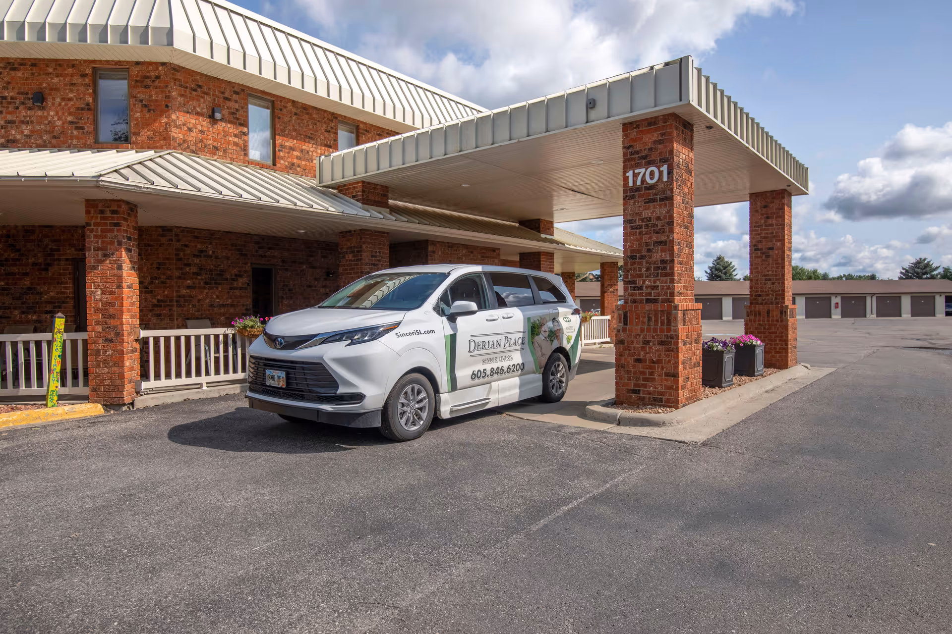Front view of Derian Lodge Senior Living entrance with a parked van