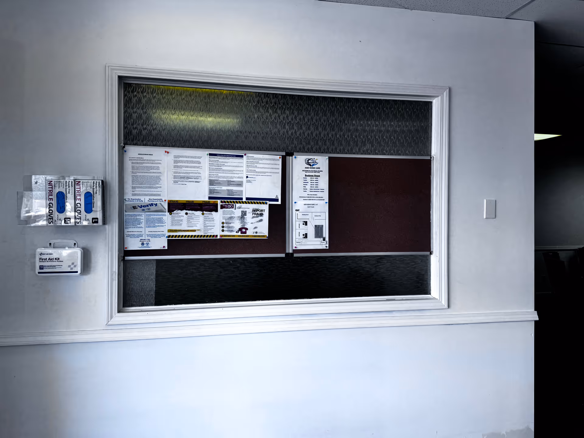 Interior hallway with a large bulletin board filled with notices.