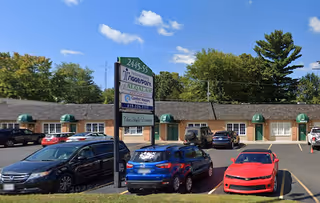 Exterior view of Comfort Keepers Toledo facility with parking lot and green awnings.