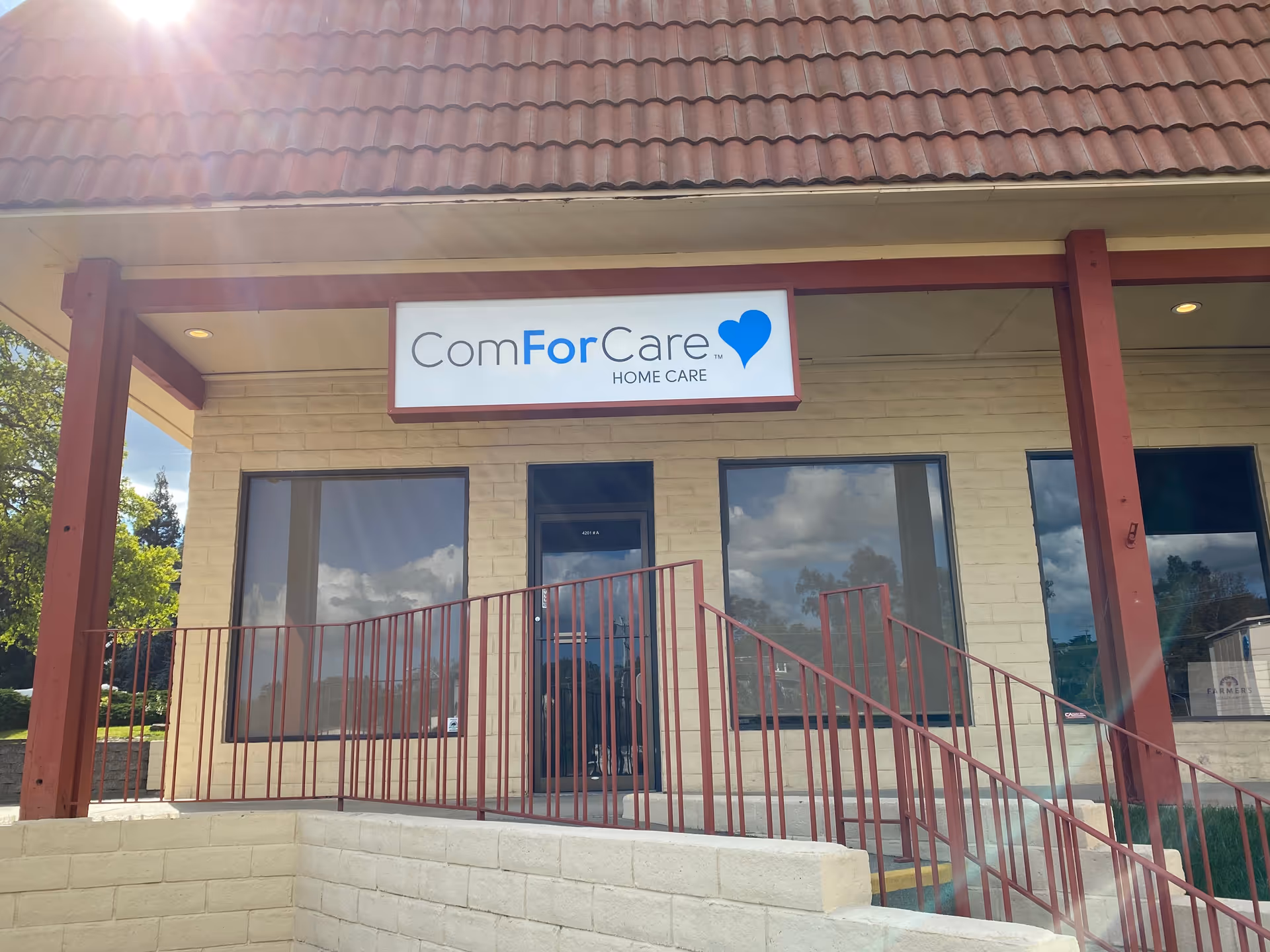Front view of ComForCare Home Care building with signs, windows, and a ramp