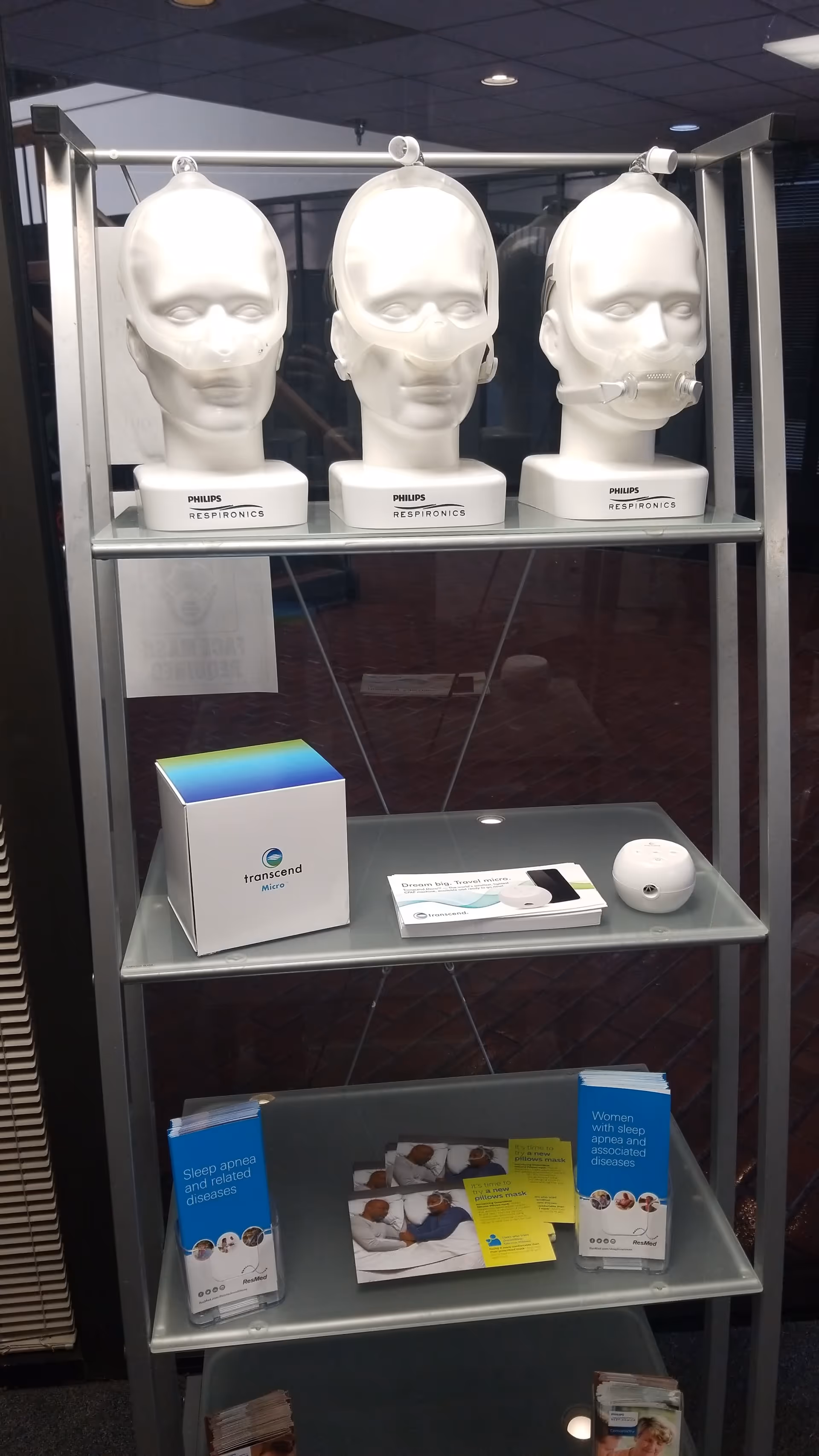Display shelf showcasing medical training mannequins, CPAP devices, and patient education brochures.