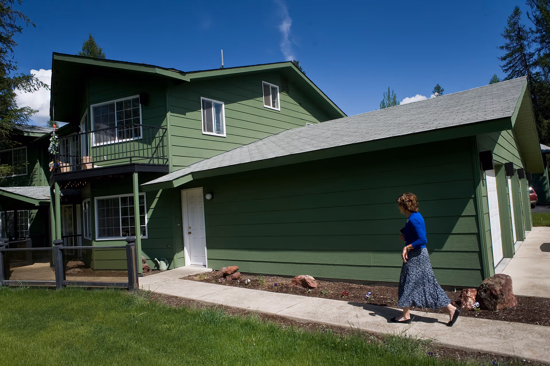Exterior of Havenwood Home Care Boise building with a woman walking along the sidewalk.