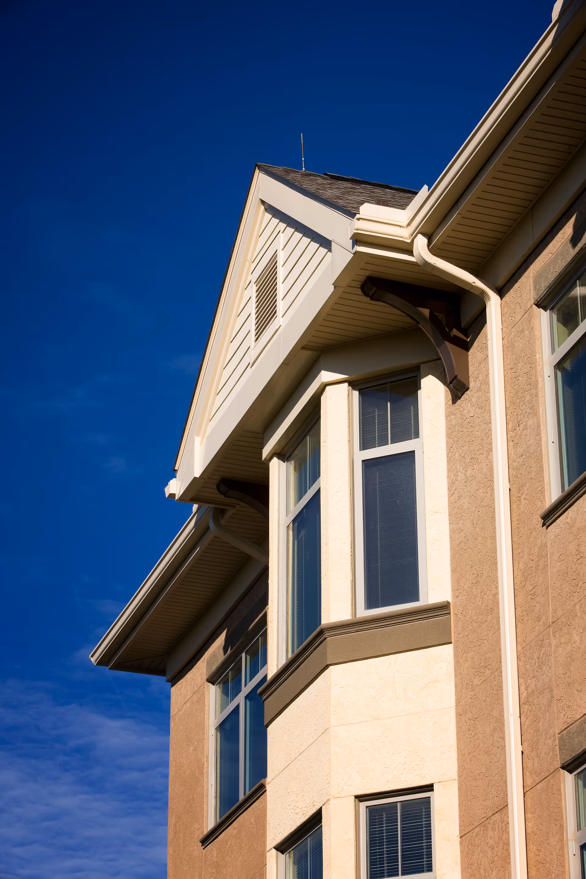 Exterior view of a Providence Point senior living building against blue sky.