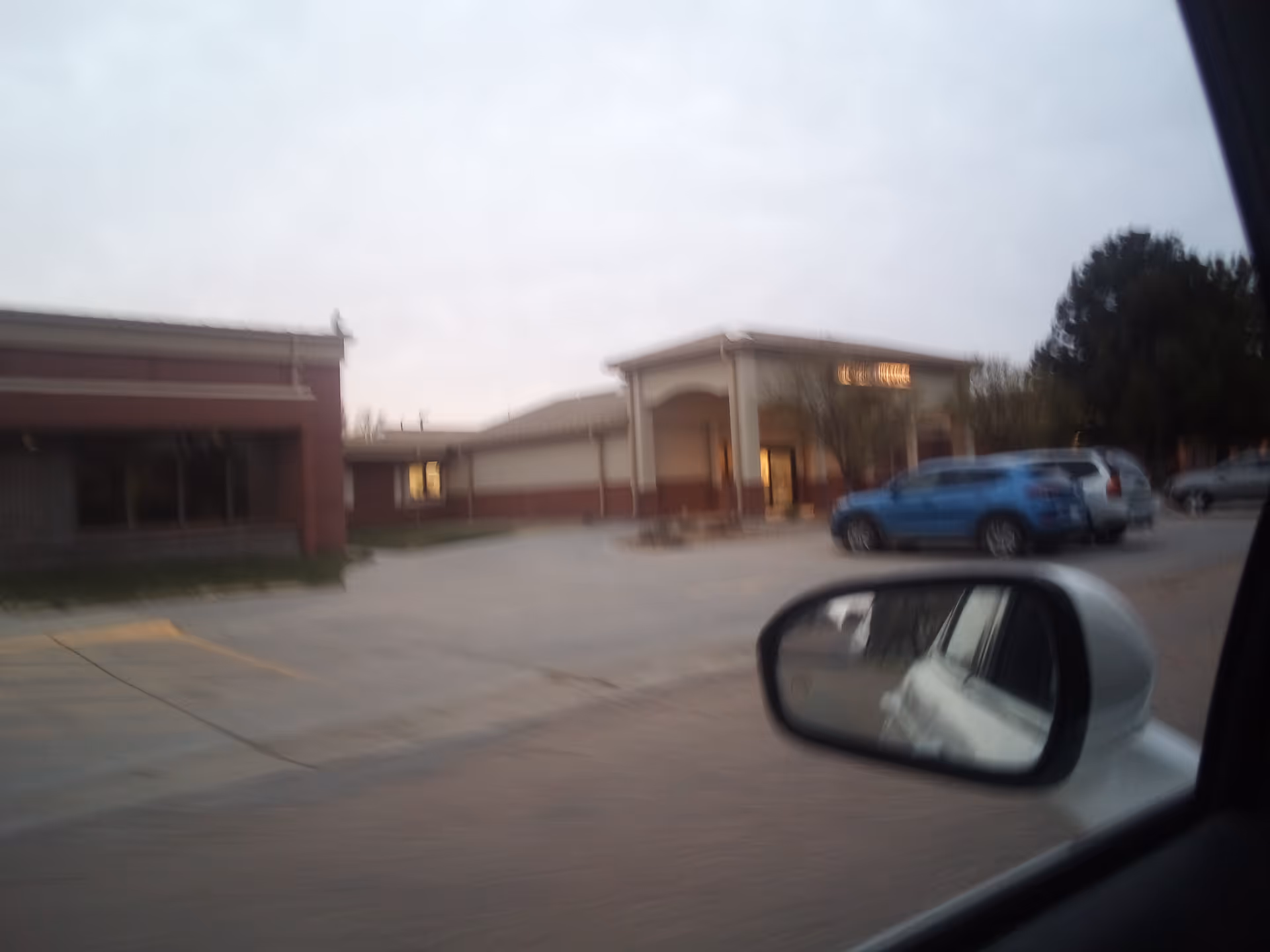 Exterior view of Stevens County Hospital with a parking lot and entrance canopy.