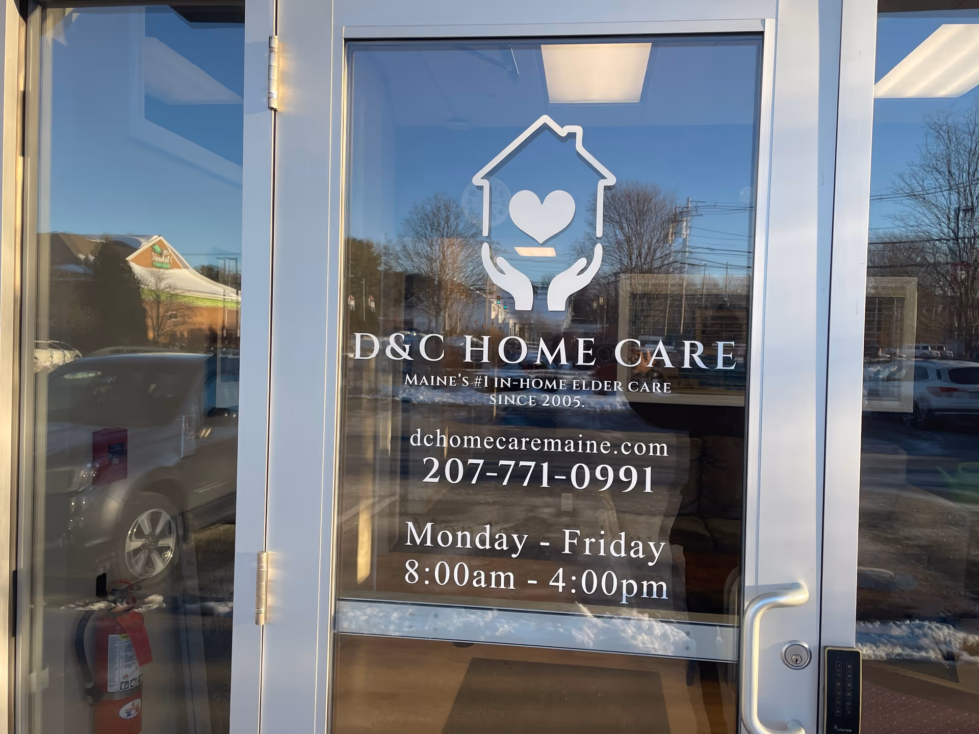 Glass entrance door displays D&C Home Care logo, name, and hours.