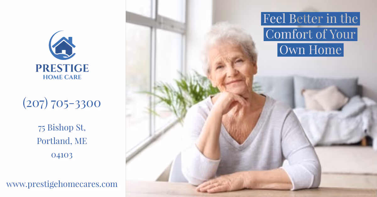 Smiling elderly woman sits at a table by a window with Prestige Home Care branding.