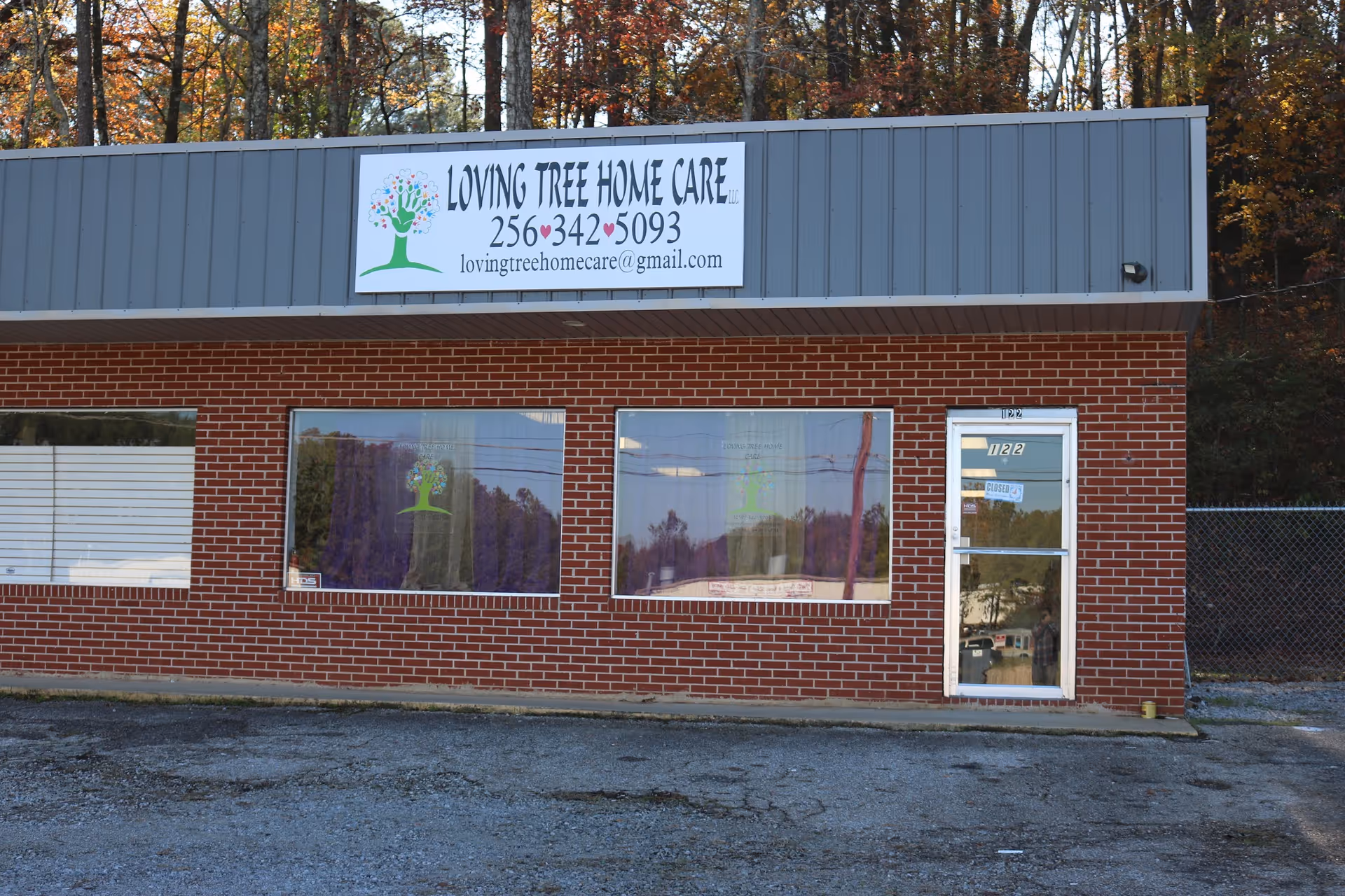 Brick building with Loving Tree Home Care sign and front entrance