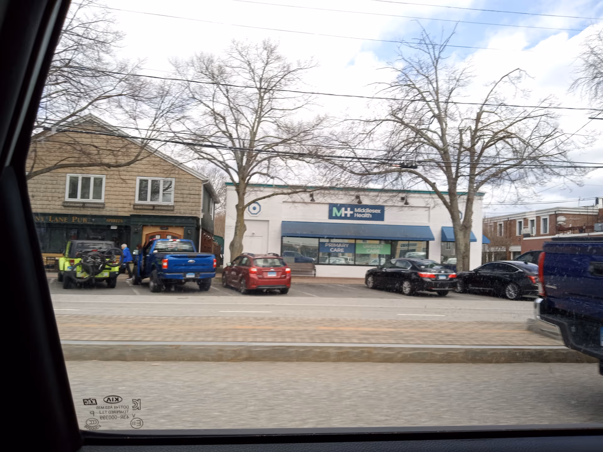 Exterior street view of Middlesex Health Urgent Care Old Saybrook storefront with parked cars