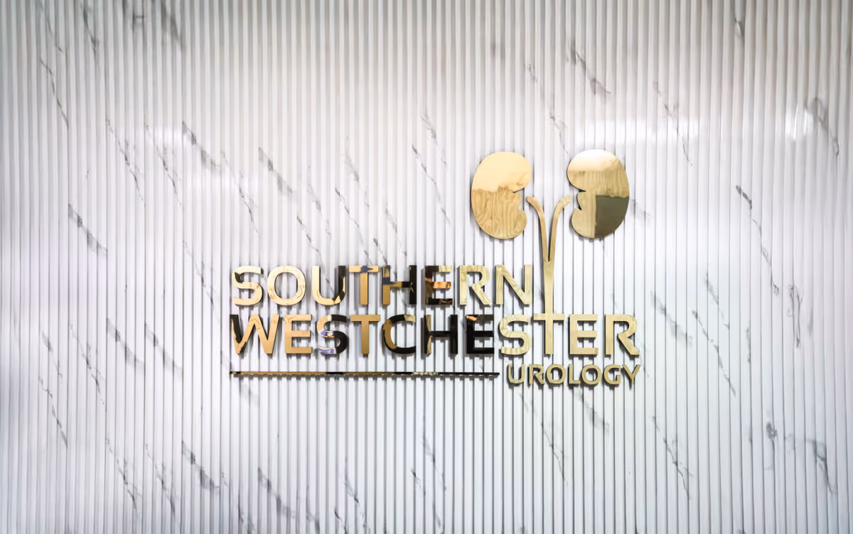 Marble wall with gold signage reading Southern Westchester Urology PLLC