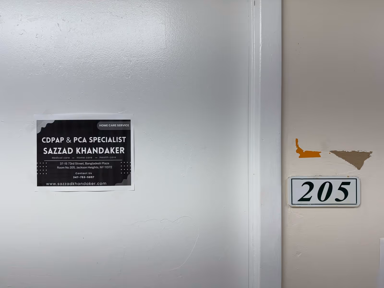 Interior hallway with a CDPAP & PCA Specialist sign and 205 room plaque.