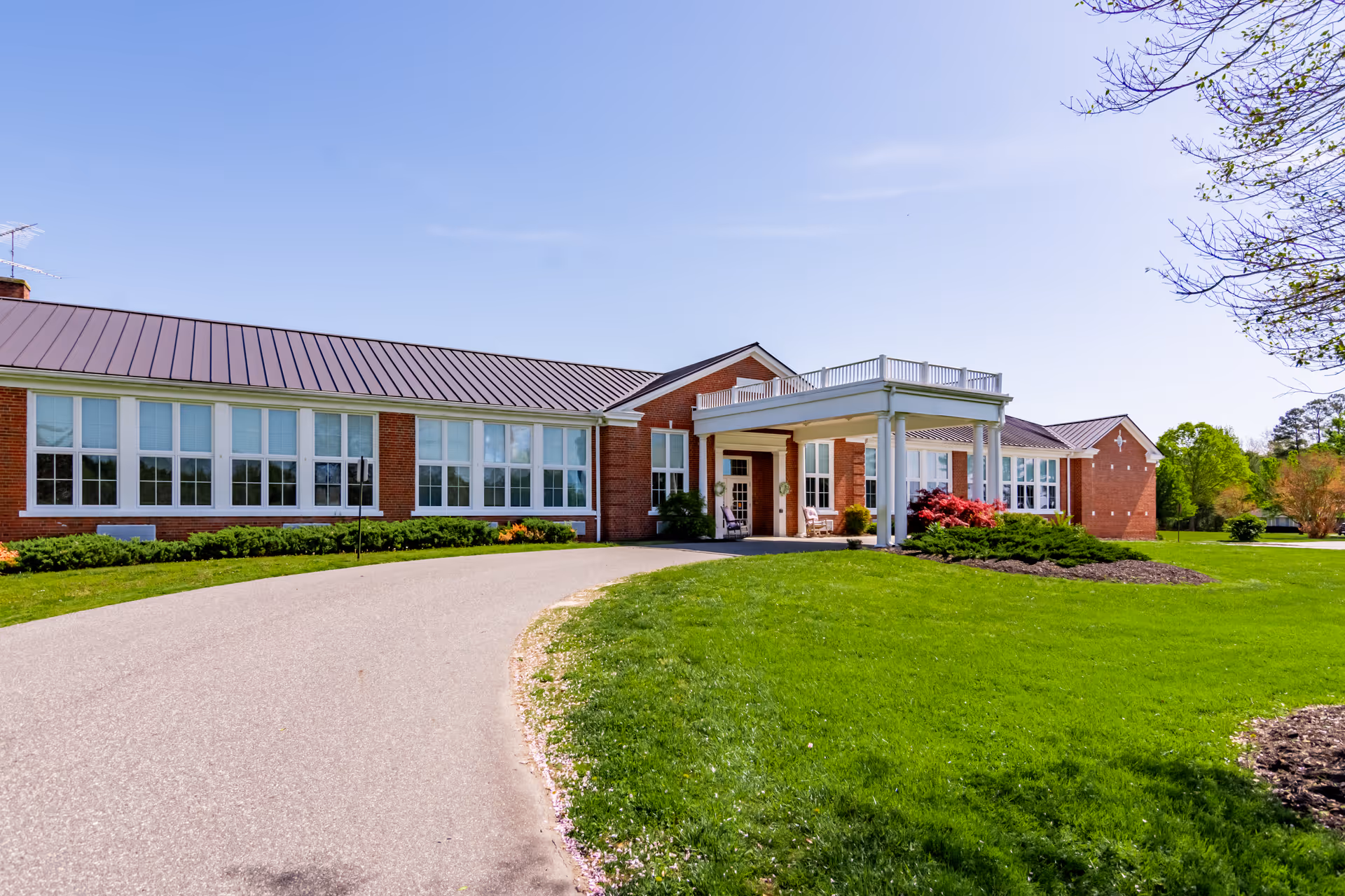 Exterior view of Commonwealth Senior Living at Farnham with brick facade and entrance.