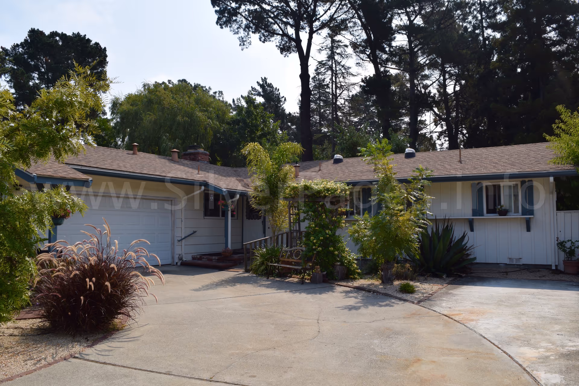 Single-story Granada Care Home No 1 exterior with curved driveway and landscaped front yard.