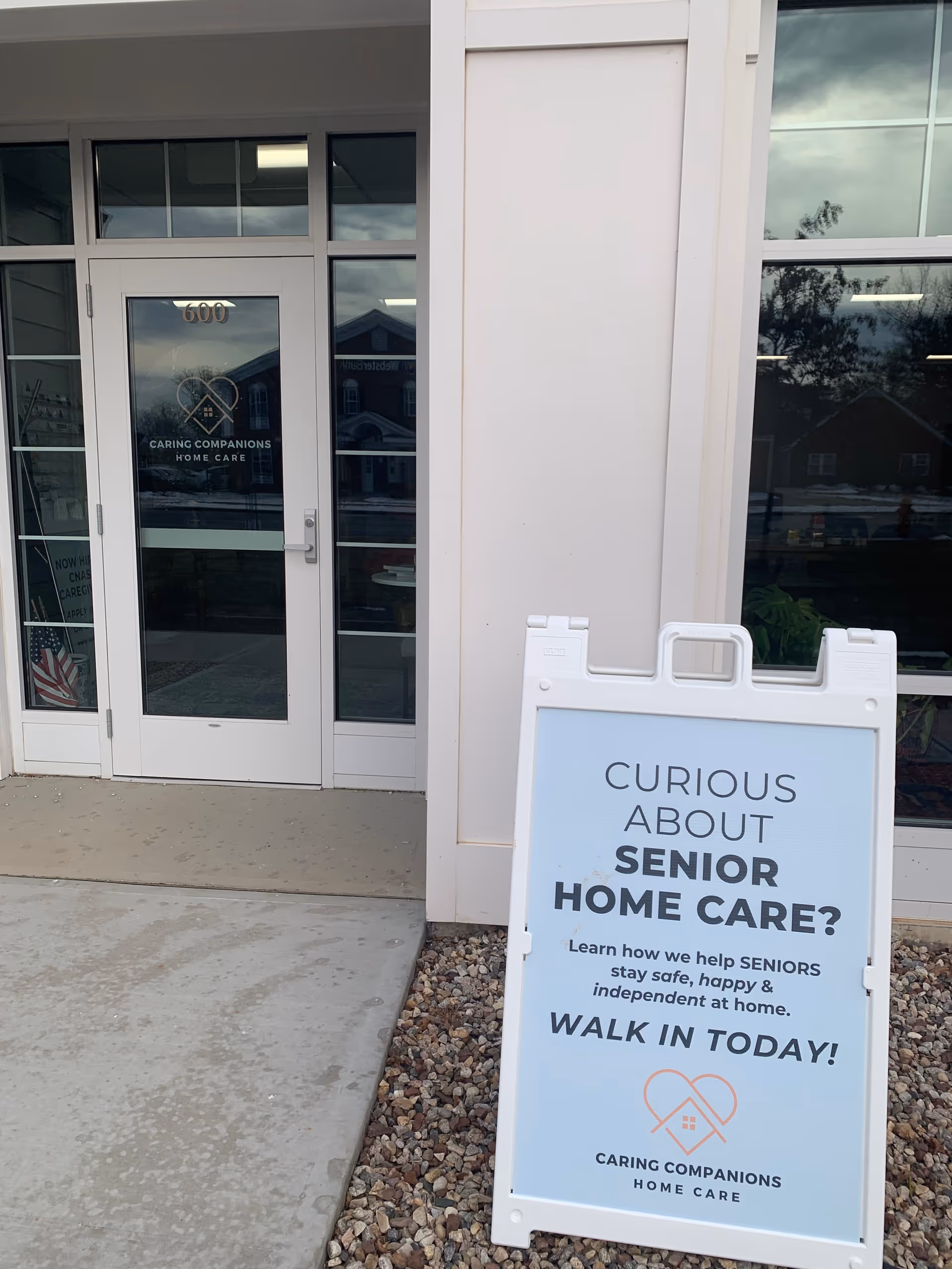 Front entrance of Caring Companions Home Care with a sidewalk sign