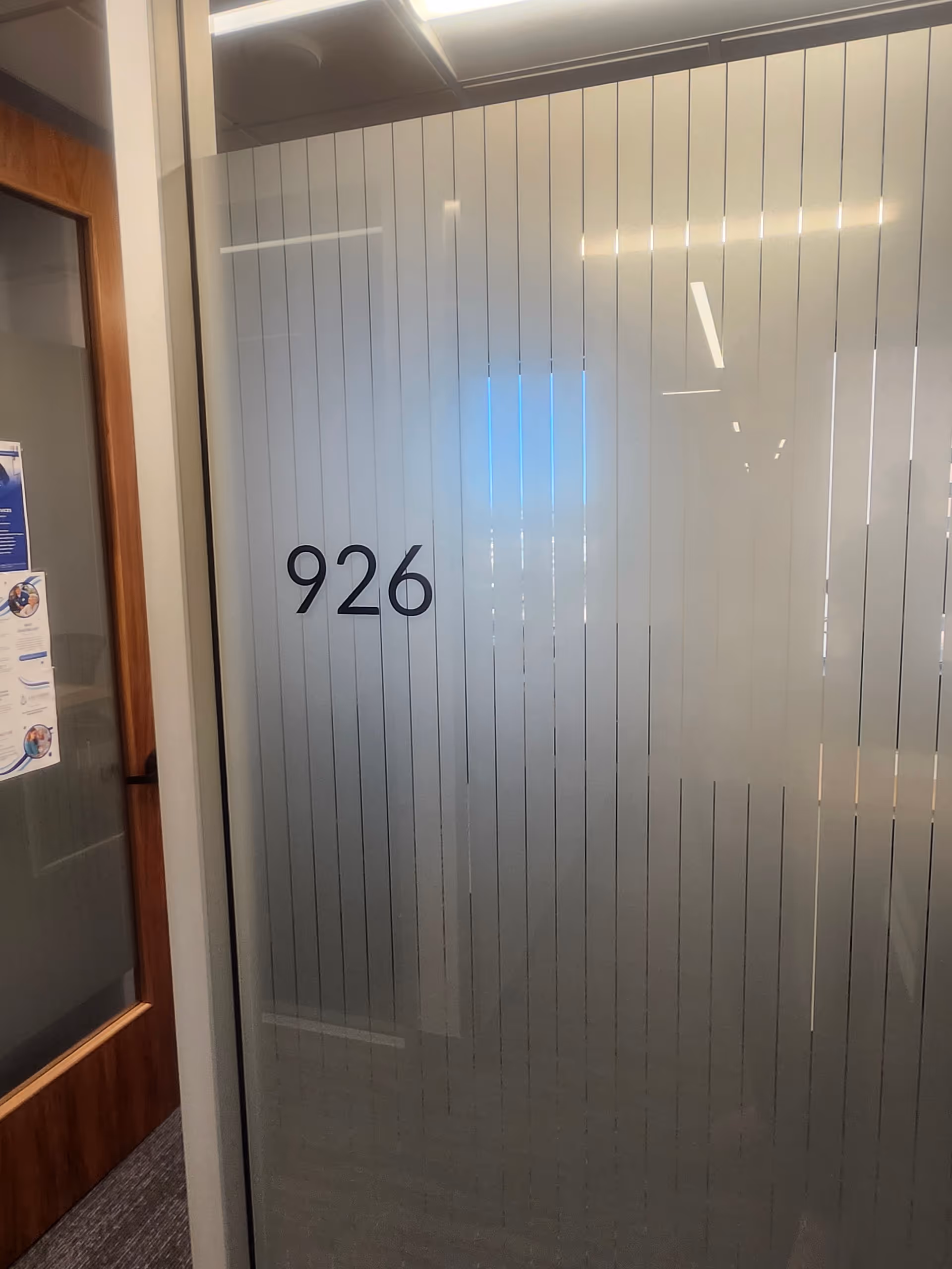 Frosted glass door marked 926 in an interior hallway