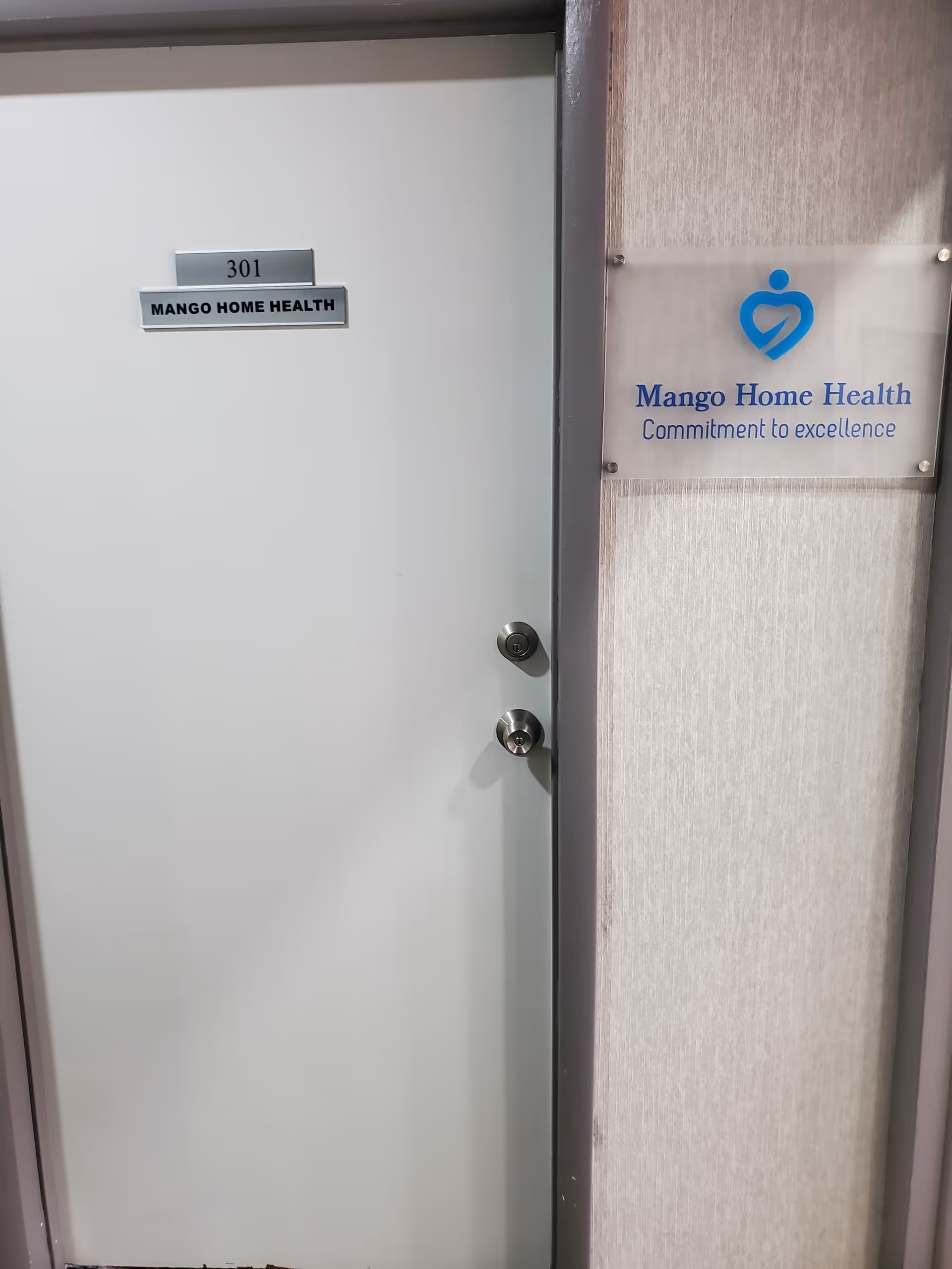 Interior door labeled 301 beside Mango Home Health sign on the wall.