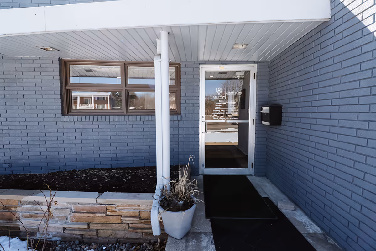 Entrance to Safeway Home Healthcare facility with blue brick exterior and glass door.