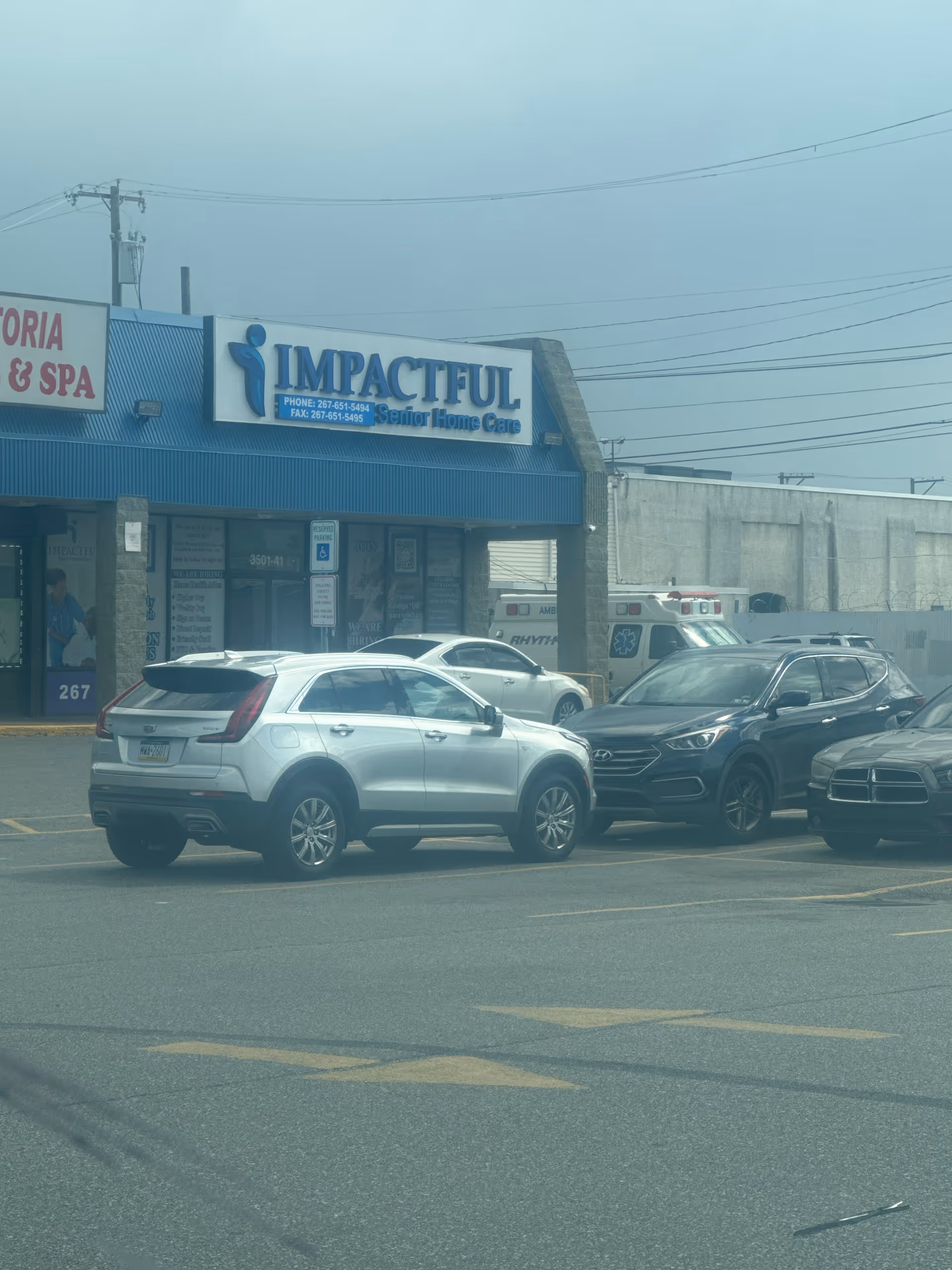 Front view of Impactful Senior Home Care storefront with parked cars