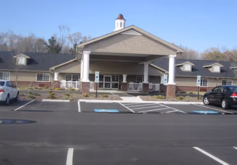 Senior living facility Currituck House exterior with covered entrance and parking