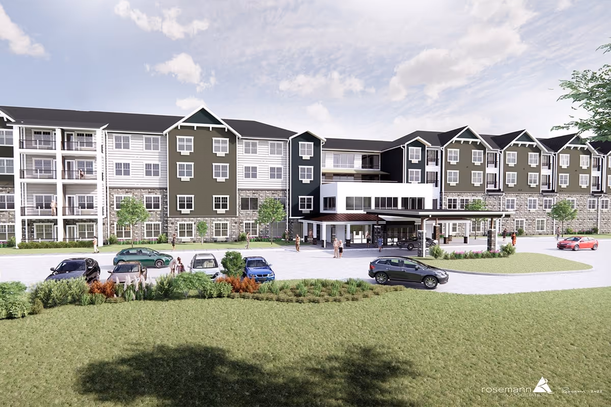 Front exterior of a multi-story senior living building with parked cars and people at the entrance.