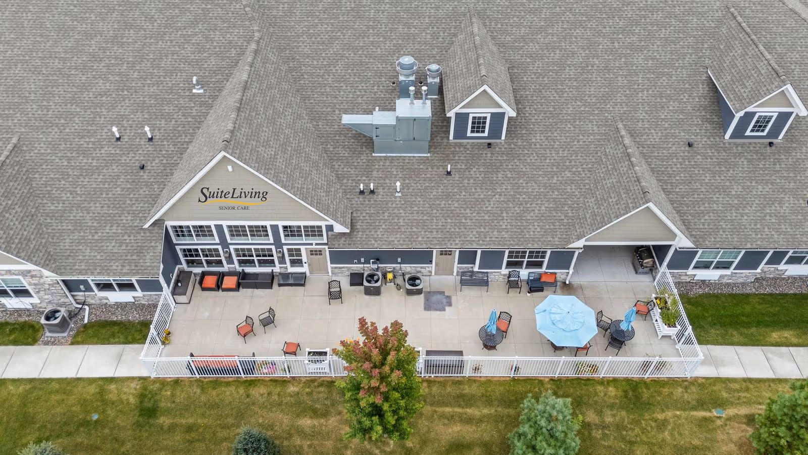 Aerial view of Suite Living of Anoka senior care facility with an outdoor patio and seating.