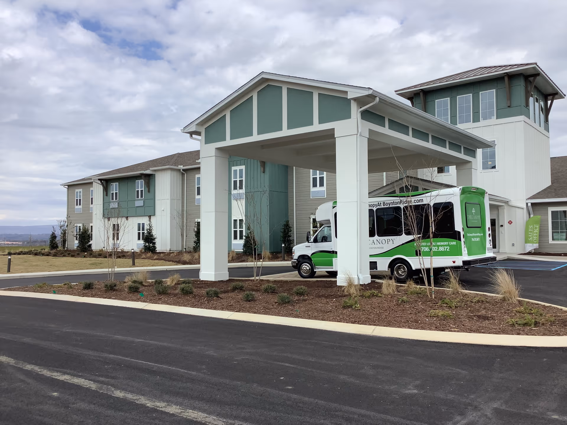 Exterior view of The Canopy at Boynton Ridge showing the entrance and shuttle.