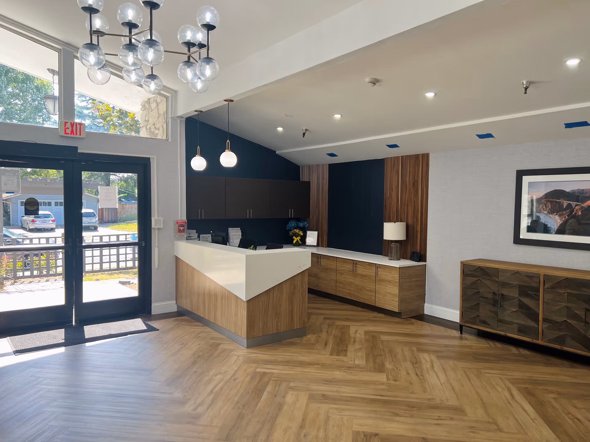Sunnyvale Post-Acute Center lobby reception with wood-front desk and cabinets.