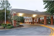 Front entrance of Heron Point of Chestertown with a curved driveway, brick columns, and covered canopy.