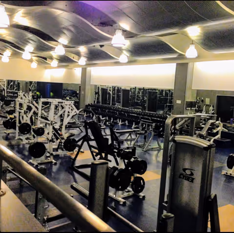 Interior gym with weight machines and mirrors in a senior living facility