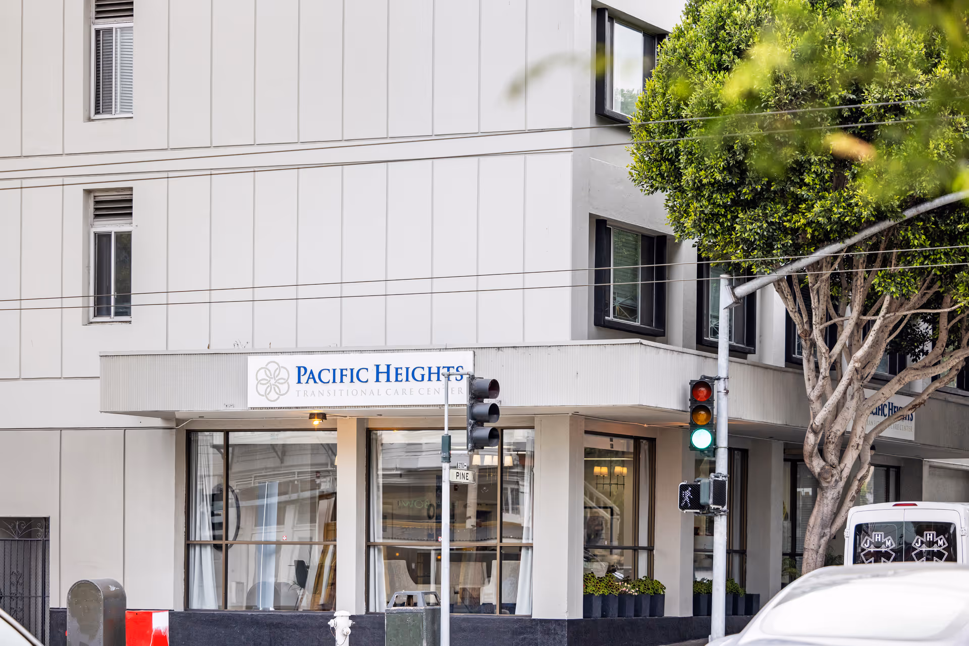 Street-level view of Pacific Heights Transitional Care Center building with entrance sign.