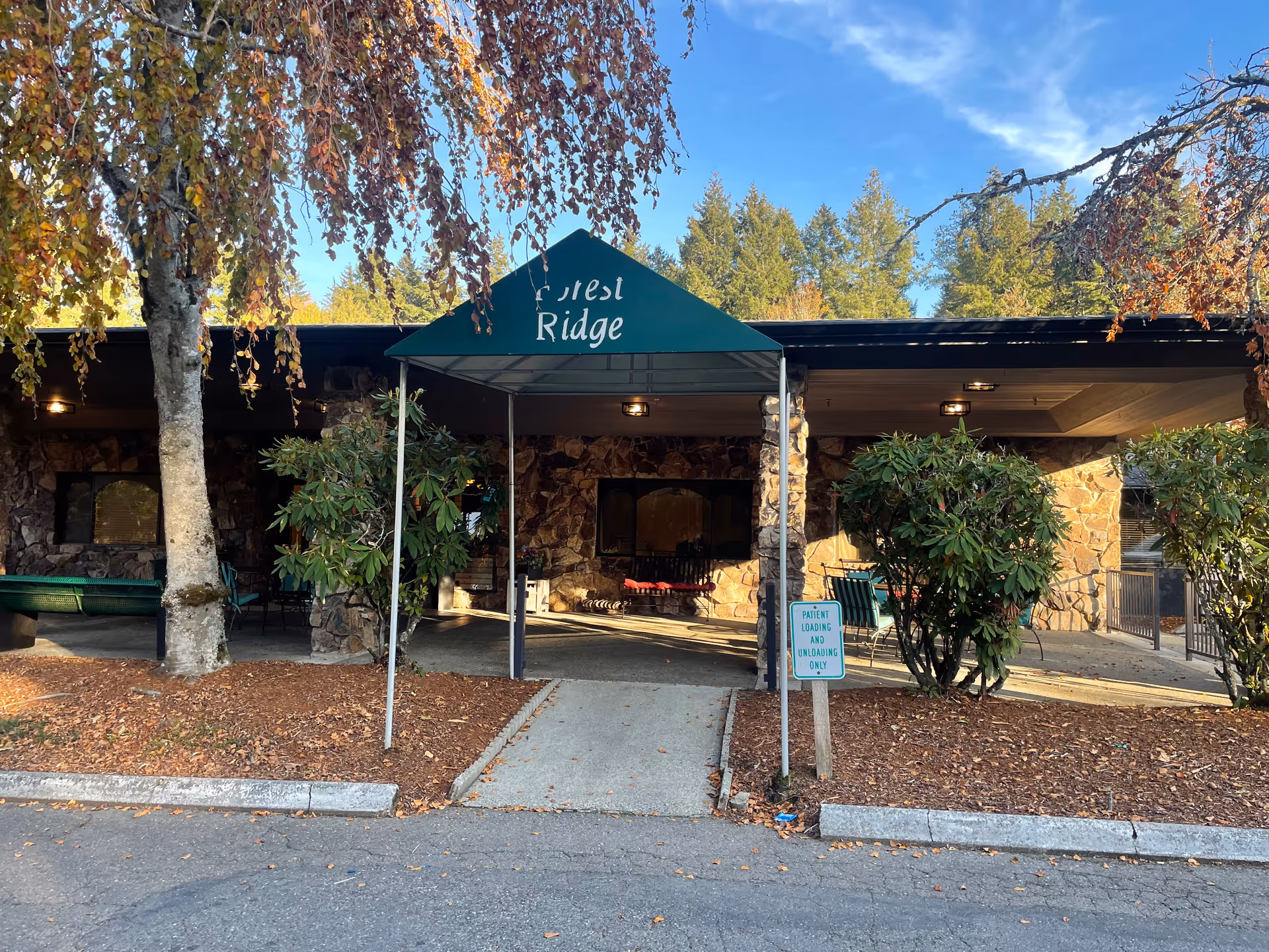Exterior view of Forest Ridge entrance with stone façade and green canopy