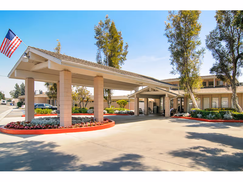 Exterior view of Mirada Hills facility with a covered entrance and landscaped beds.