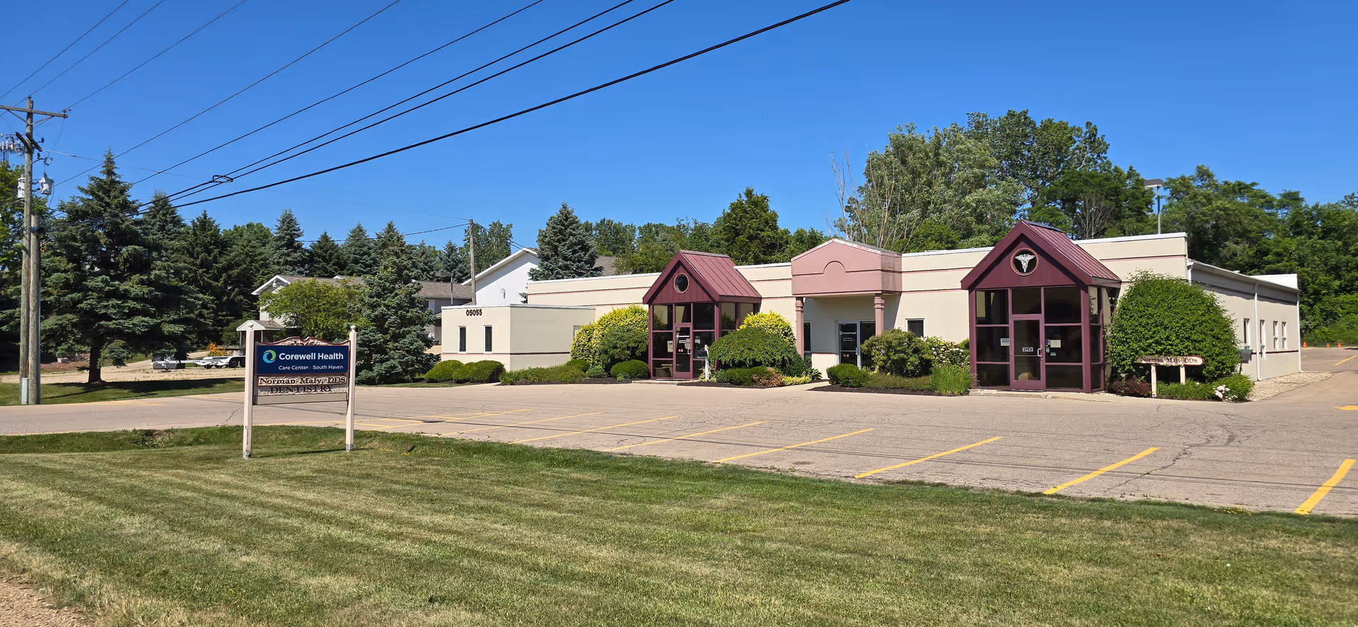 Front view of Corewell Health Hospice and Palliative Care South Haven building with purple entrances.