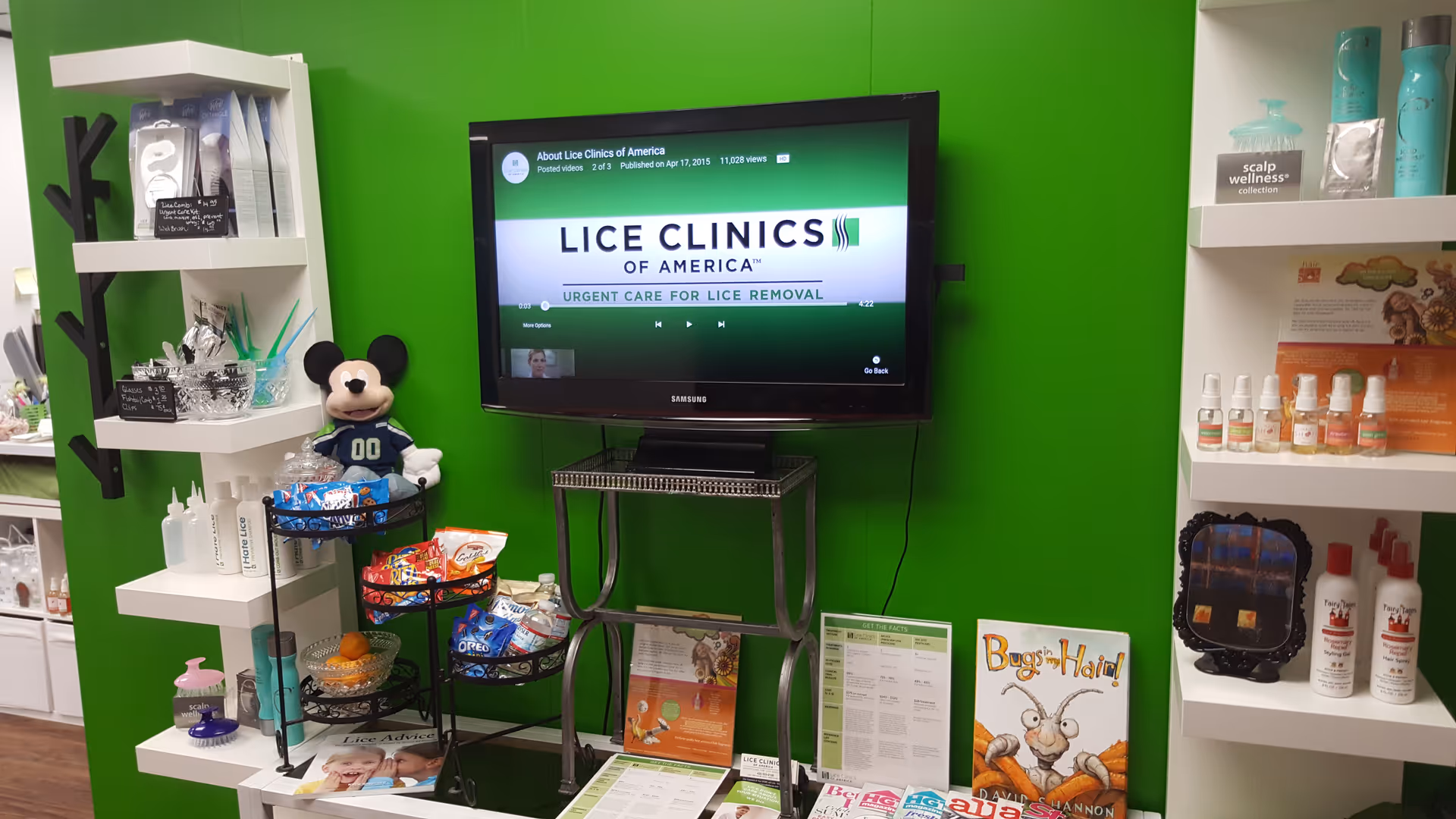 Bright interior featuring a TV screen on a metal stand and shelves of products.