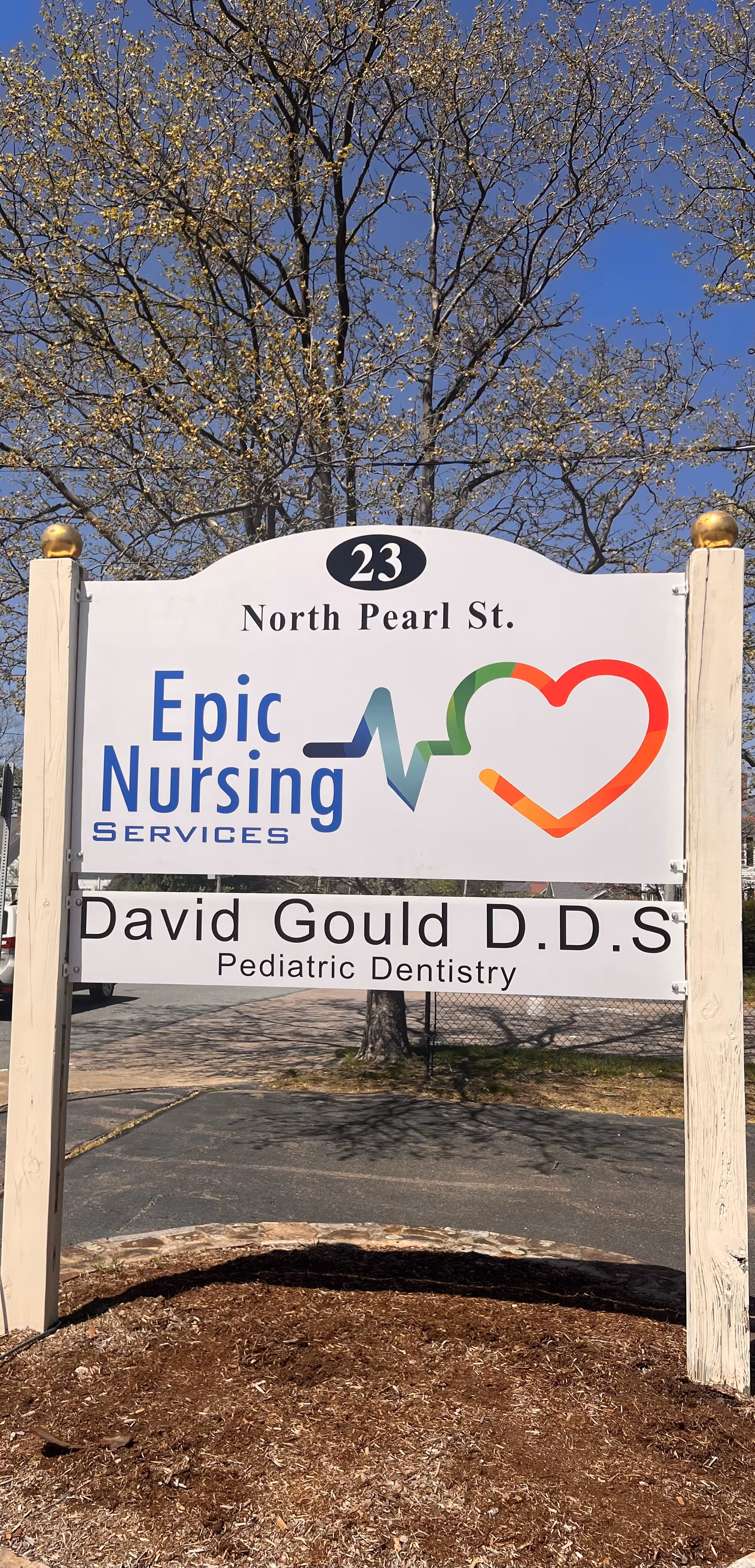 Exterior sign for Epic Nursing Services featuring heart logo and pediatric dentistry text.