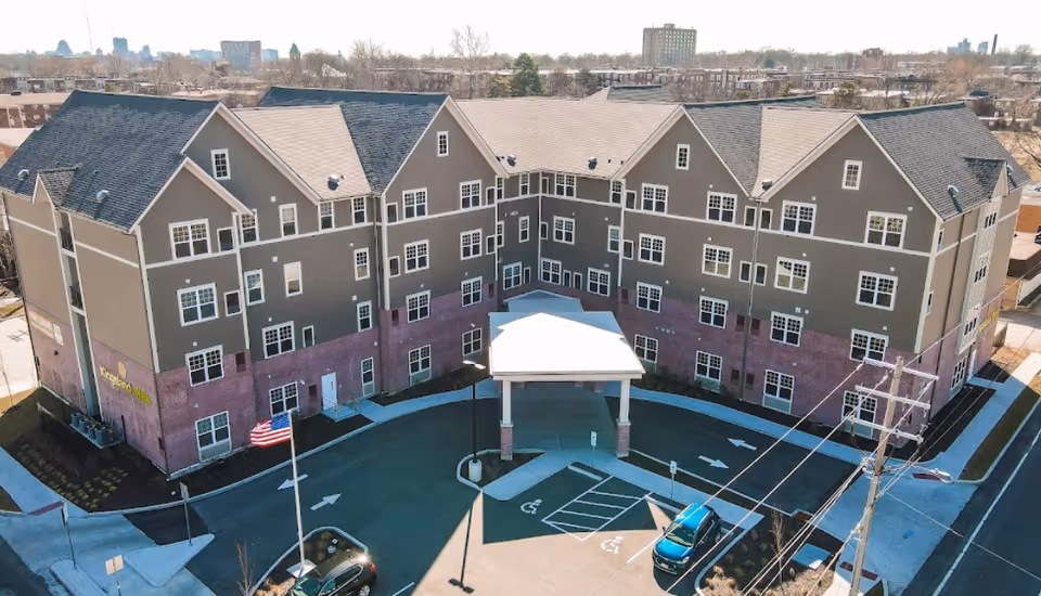 Exterior view of Kingsland Walk Senior Living building with covered entrance and parking.
