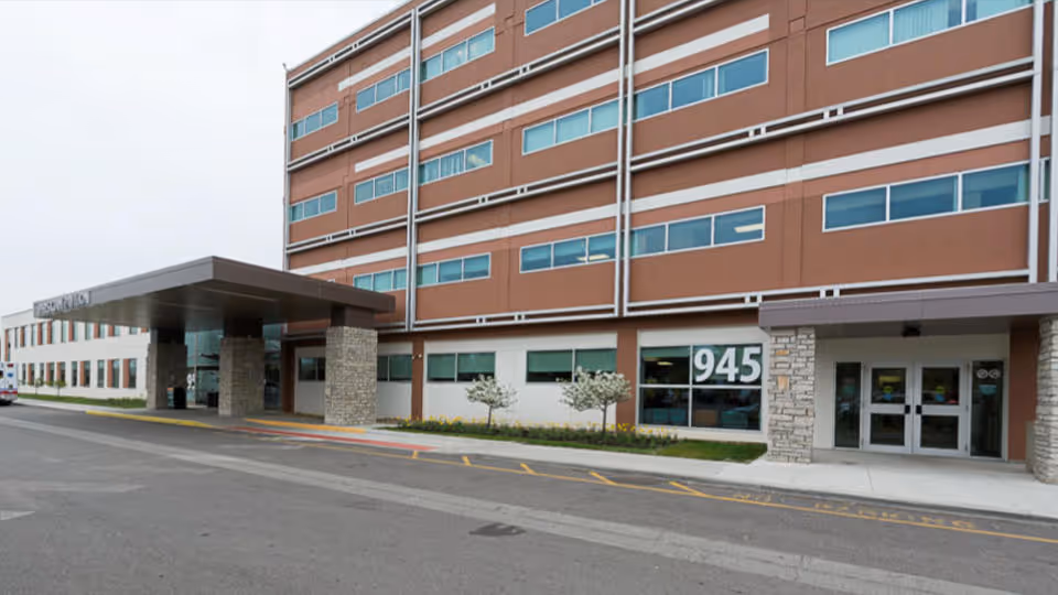 Exterior view of Physician Pavilion 945 with a covered entrance and glass doors.