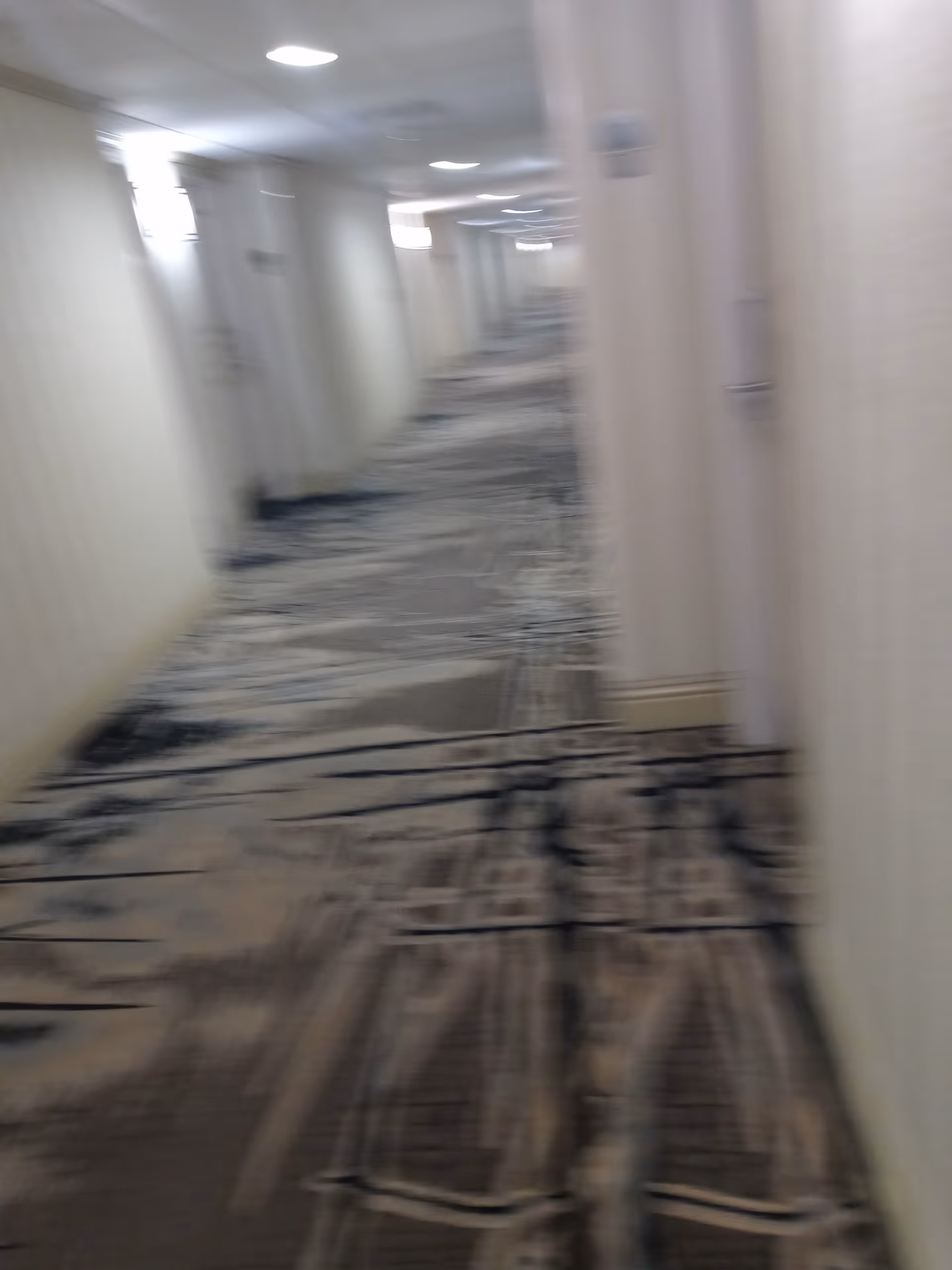 Blurry interior hallway in a senior living facility under renovation.
